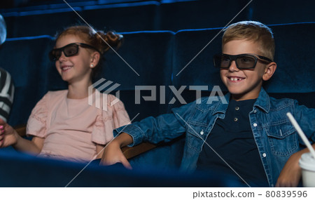 Happy small children with 3d glasses in the cinema, watching film. 80839596