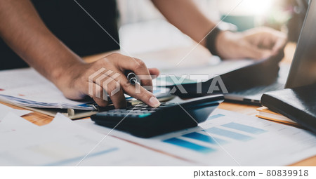Close up accountant working on desk using calculator for calculate finance report at home office Close up accountant working on desk using calculator for calculate finance report at home office 80839918