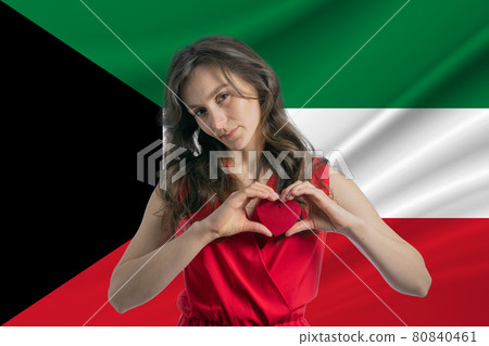 Love Kuwait A girl holds a heart on her chest in her hands against the background of the flag of Kuwait The concept of patriotism Love Kuwait A girl holds a heart on her chest in her hands against the background of the flag of Kuwait The concept of patriotism 80840461