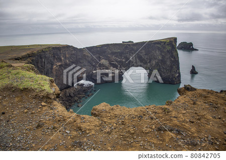 View on natural arches at Reynisfjara black beach in southern Iceland during daytime 80842705