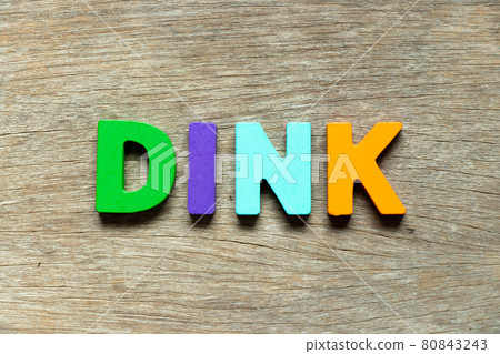 Color alphabet letter in word DINK (Abbreviation of Double income, no kids or Dual income, no kids) on wood background 80843243