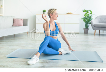 Lady practicing yoga, sitting in Ardha Matsyendrasana pose Lady practicing yoga, sitting in Ardha Matsyendrasana pose 80845031