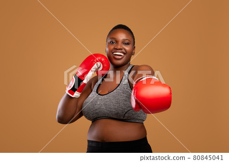 Young Black Woman Posing With Boxing Gloves At Studio 80845041