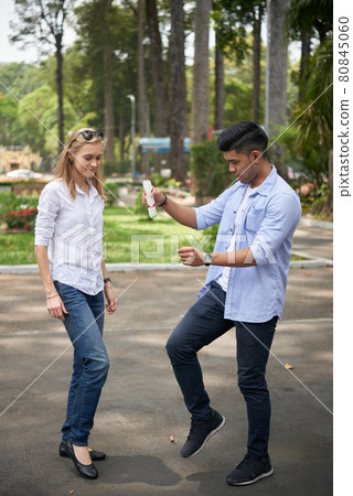 Couple Playing Traditional Chinese Jianzi Couple Playing Traditional Chinese Jianzi 80845060