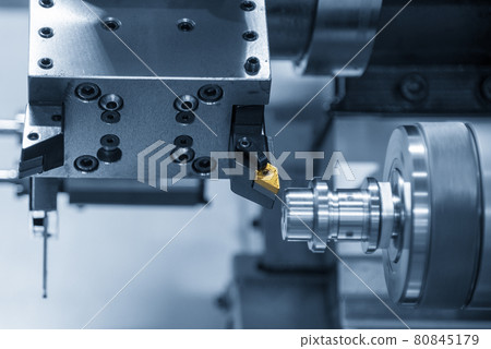 The chip insert cutting tool of CNC lathe machine cutting the metal shaft parts . The chip insert cutting tool of CNC lathe machine cutting the metal shaft parts . 80845179