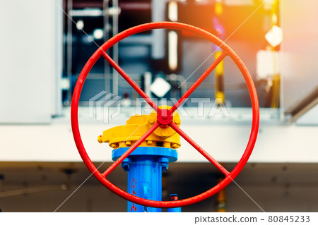 Round red valve close-up. Industrial background. Gasification or transportation natural gas. 80845233