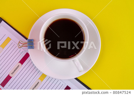 Top view white cup of strong coffee and paper binder. 80847524