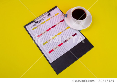 Clipboard with cup of strong coffee in a white cup. Clipboard with cup of strong coffee in a white cup. 80847525