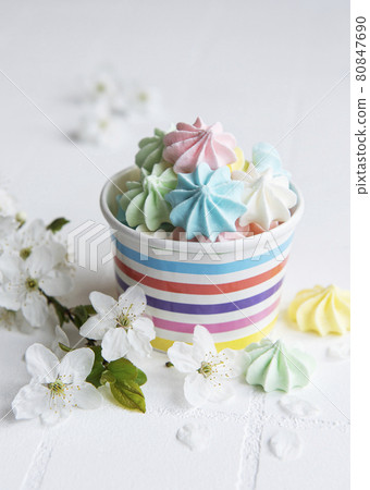 Small colorful meringues in the  paper bowl 80847690