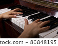 A girl clipping piano keyboard, close up 80848195