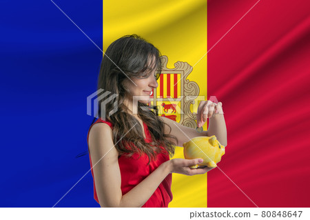 Economy in Andorra. Accumulating and saving money in Andorra. Woman putting money coin in piggy bank for saving money and plan finance Economy in Andorra. Accumulating and saving money in Andorra. Woman putting money coin in piggy bank for saving money and plan finance 80848647