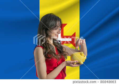 Economy in Madeira. Accumulating and saving money in Madeira. Woman putting money coin in piggy bank for saving money and plan finance Economy in Madeira. Accumulating and saving money in Madeira. Woman putting money coin in piggy bank for saving money and plan finance 80848663