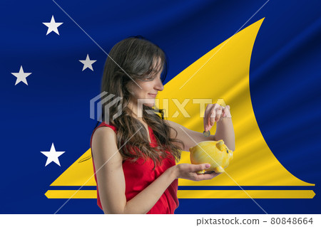 Economy in Tokelau. Accumulating and saving money in Tokelau. Woman putting money coin in piggy bank for saving money and plan finance Economy in Tokelau. Accumulating and saving money in Tokelau. Woman putting money coin in piggy bank for saving money and plan finance 80848664