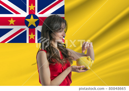 Economy in Niue. Accumulating and saving money in Niue. Woman putting money coin in piggy bank for saving money and plan finance Economy in Niue. Accumulating and saving money in Niue. Woman putting money coin in piggy bank for saving money and plan finance 80848665