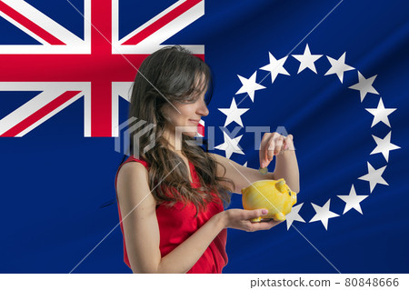 Economy in Cook Islands. Accumulating and saving money in Cook Islands. Woman putting money coin in piggy bank for saving money and plan finance Economy in Cook Islands. Accumulating and saving money in Cook Islands. Woman putting money coin in piggy bank for saving money and plan finance 80848666