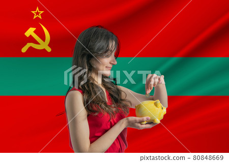 Economy in Transnistria. Accumulating and saving money in Transnistria. Woman putting money coin in piggy bank for saving money and plan finance Economy in Transnistria. Accumulating and saving money in Transnistria. Woman putting money coin in piggy bank for saving money and plan finance 80848669