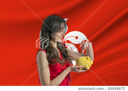 Economy in Hong Kong. Accumulating and saving money in Hong Kong. Woman putting money coin in piggy bank for saving money and plan finance Economy in Hong Kong. Accumulating and saving money in Hong Kong. Woman putting money coin in piggy bank for saving money and plan finance 80848672