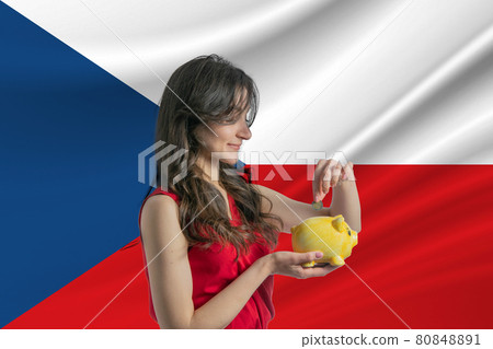 Economy in Czech Republic. Accumulating and saving money in Czech Republic. Woman putting money coin in piggy bank for saving money and plan finance Economy in Czech Republic. Accumulating and saving money in Czech Republic. Woman putting money coin in piggy bank for saving money and plan finance 80848891