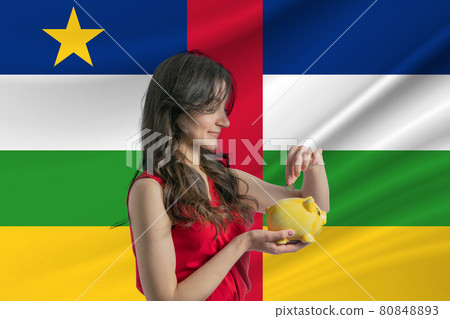 Economy in Central African Republic. Accumulating and saving money in Central African Republic. Woman putting money coin in piggy bank for saving money and plan finance Economy in Central African Republic. Accumulating and saving money in Central African Republic. Woman putting money coin in piggy bank for saving money and plan finance 80848893