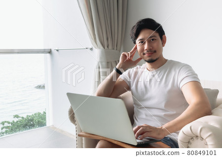 Happy man work in the hotel with sea view. Staycation concept. Happy man work in the hotel with sea view. Staycation concept. 80849101