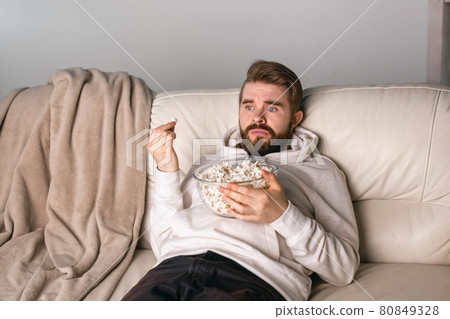 Portrait of guy watching TV series online. Online cinema and video streaming service concept. 80849328