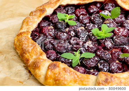 Summer galette with cherries on brown concrete background Summer galette with cherries on brown concrete background 80849600