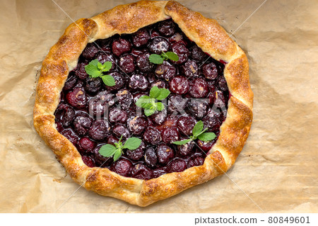 Summer galette with cherries on brown concrete background Summer galette with cherries on brown concrete background 80849601