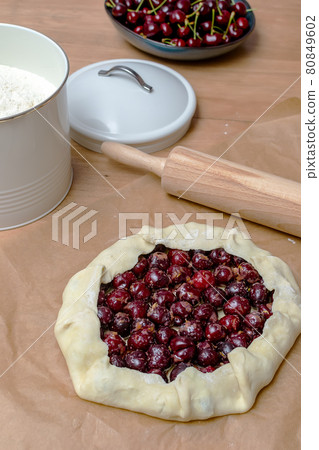 Summer galette with cherries on brown concrete background Summer galette with cherries on brown concrete background 80849602