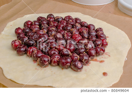 Summer galette with cherries on brown concrete background 80849604