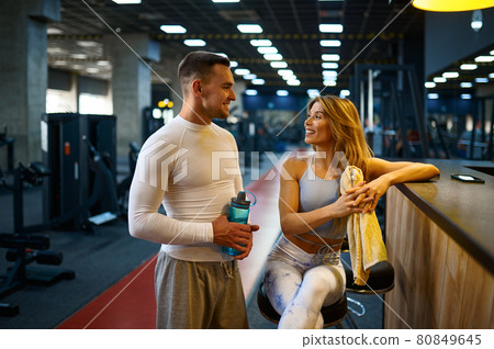 Sportive couple relax at the counter in gym bar Sportive couple relax at the counter in gym bar 80849645