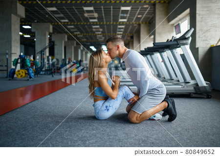 Love couple kissing, fitness training in gym Love couple kissing, fitness training in gym 80849652