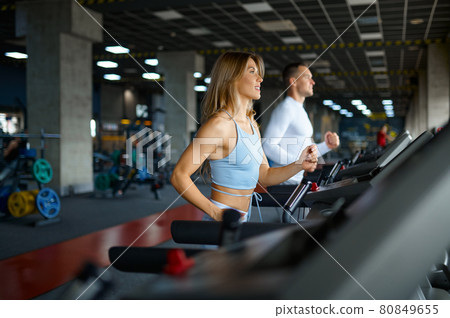 Sportive couple on the treadmill, training in gym 80849655