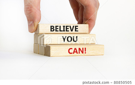 Believe you can symbol. Wooden blocks with words 'Believe you can'. Businessman hand. Beautiful white background. Copy space. Business, motivational and believe you can concept. Believe you can symbol. Wooden blocks with words 'Believe you can'. Businessman hand. Beautiful white background. Copy space. Business, motivational and believe you can concept. 80850505