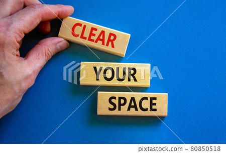 Clear your space symbol. Wooden blocks with words 'Clear your space'. Beautiful blue background, businessman hand. Business, clear your space concept, copy space. 80850518