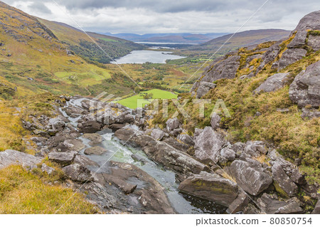 Typical Irish landscape with green meadows and rough mountains during daytime Typical Irish landscape with green meadows and rough mountains during daytime 80850754