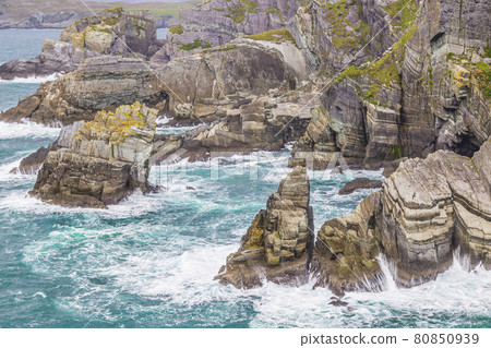 Rough cliff line at Mizen head lighthouse in southern west Ireland during daytime 80850939