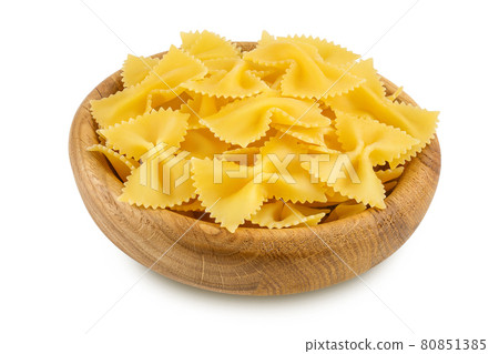 Bow tie pasta in wooden bowl isolated on white background with clipping path and full depth of field. 80851385