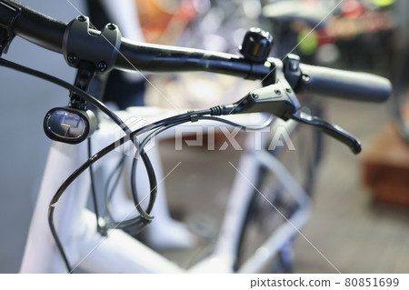 Bicycle handlebars with handbrake and flashlight closeup 80851699
