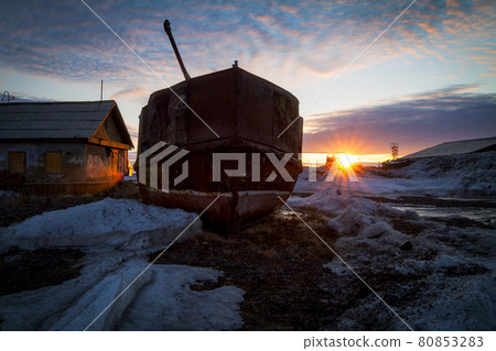 Abandoned ship ashore near an old house. 80853283