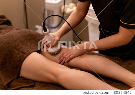 Women undergoing treatment at an esthetic salon (radio waves, thighs) Women undergoing treatment at an esthetic salon (radio waves, thighs) 80854842