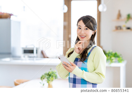 在餐廳/廚房使用智能手機的年輕家庭主婦 80855341