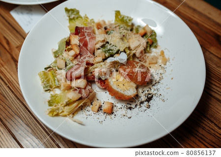 Caesar salad with chicken, cherry tomatoes, lettuce 80856137