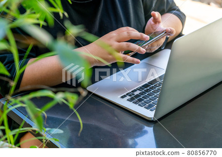 Young girl using smartphone in the garden Young girl using smartphone in the garden 80856770