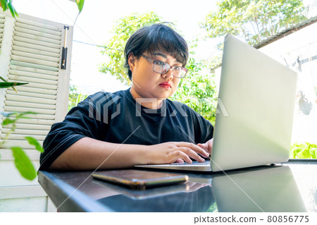 Young Asian woman work from home on laptop Young Asian woman work from home on laptop 80856775
