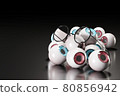Round-shaped glasses were placed on several blue and brown eyeballs on a black floor and a dark background. The concept of eye problems and eye business concept. 80856942