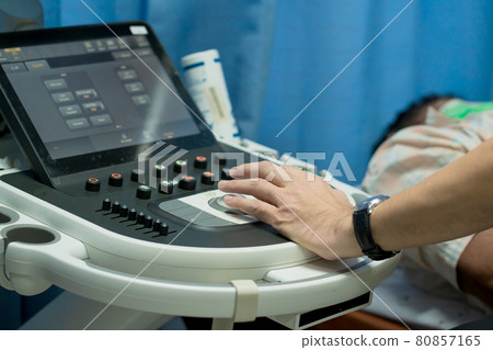 Closeup of man getting an ultrasound scan on abdominal by doctor. Closeup of man getting an ultrasound scan on abdominal by doctor. 80857165