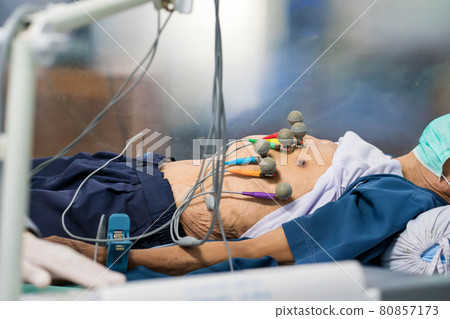 ECG or EKG of man with electrodes for electrocardiogram records on bed in hospital ECG or EKG of man with electrodes for electrocardiogram records on bed in hospital 80857173