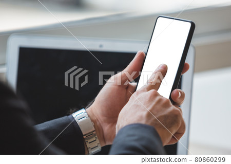 Close-up male hands finger touch screen display smartphone with blank white screen in cafe. 80860299