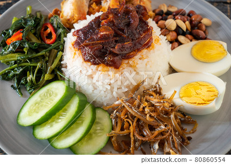 Nasi lemak is a Malay fragrant rice dish cooked in coconut milk and pandan leaf. 80860554