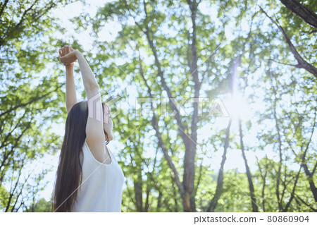 Young Japanese woman relaxing in the woods 80860904